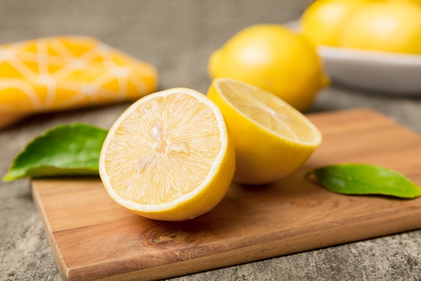 top view with copy space for fresh and ripe lemons on cutting board healthy food background elegant background of lemon and lemon slices with squeezer colored background - Шоколадная паста на основе авокадо