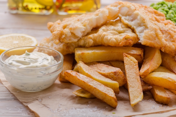 traditional british street food fish and chips with tartar sauce and lemon on bakery paper - Соус Тартар