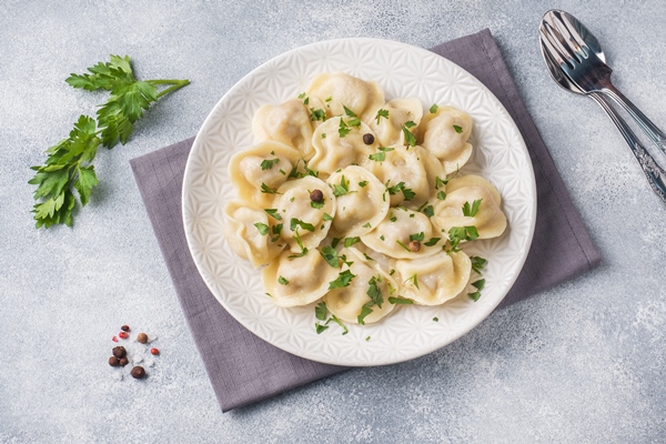 traditional pelmeni ravioli dumplings filled with meat on plate russian kitchen - Пельмени рыбные, постный стол