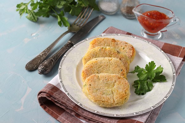 vegetarian cutlets peas semolina plate with sauce blue surface closeup copy space - Манные котлеты