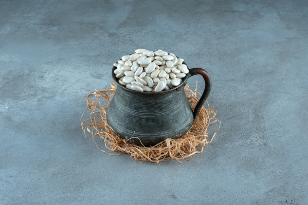 white beans in an ethnic metallic pot high quality photo - Соус из белых бобов