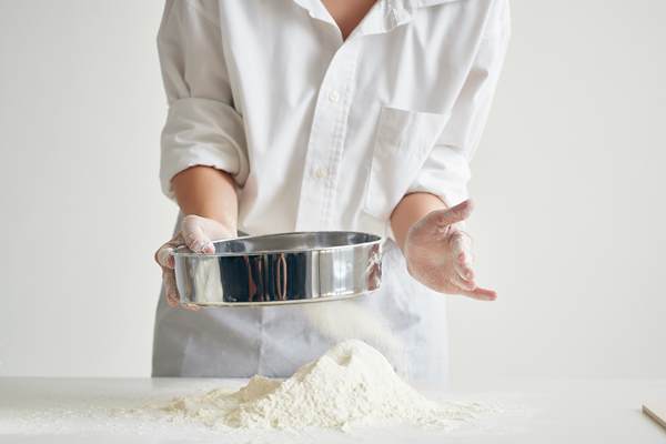 woman baker in chef uniform rolls out dough flour professional cooking 1 - Булки постные
