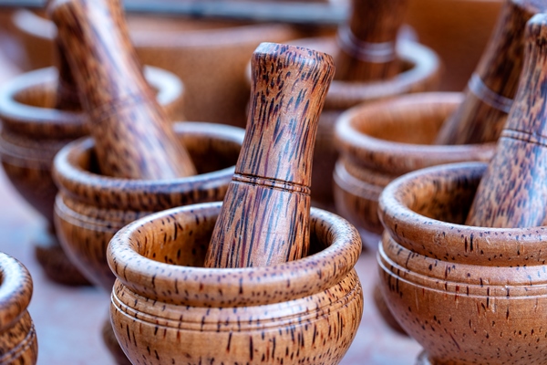 wooden mortar and pestle for sell in local street market in thailand close up thai souvenir for tourist - Салат из свежей капусты