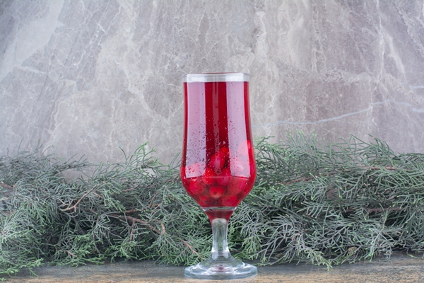 a glass of rosehips juice on marble background high quality photo - Квас из плодов шиповника