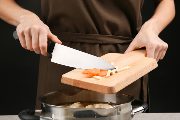 adding sliced carrot and celery into pan with delicious dumplings - Суп с белыми грибами, постный