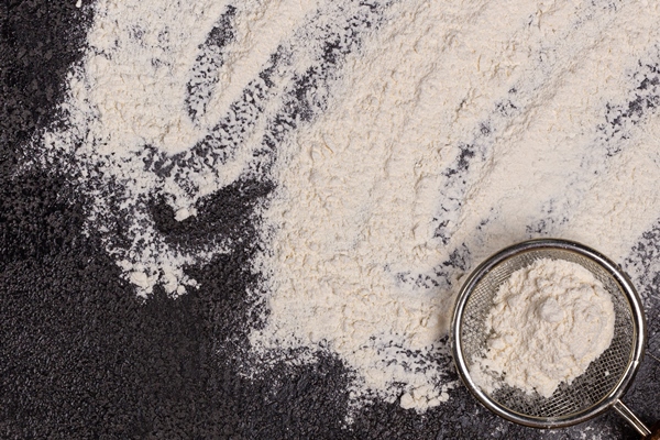 baking background with free space for your text flour in a bowl eggs and wheat on a black table - Драники с шампиньонами