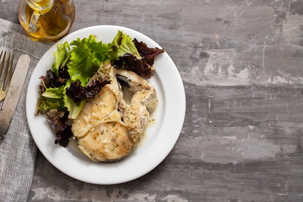 boiled fish with sauce and green salad on white plate - Ботвинья (способ второй)