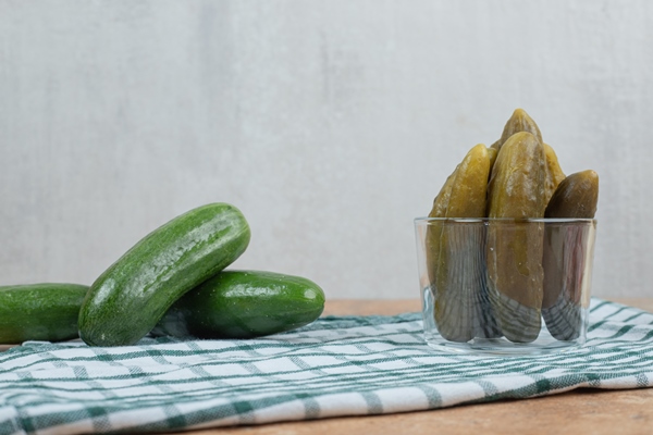 bowl of pickles and fresh cucumbers on tablecloth - Окрошка из рыбы