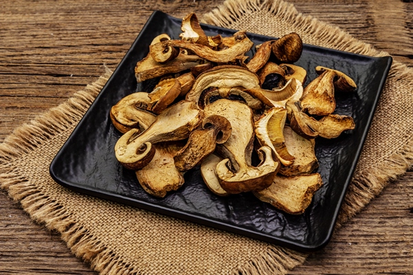 dried porcini mushrooms traditional ingredient for cooking healthy food black ceramic plate sackcloth napkin - Похлёбка постная с грибами