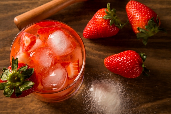 fresh made strawberry caipirinha on wooden background - Клубничный квас