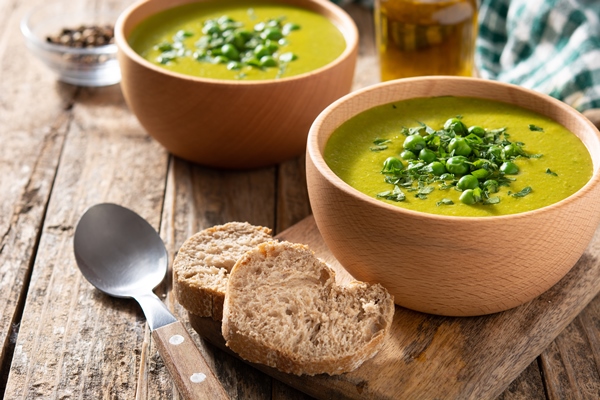 green pea soup in a bowl on rustic wooden table - Суп картофельный с горохом
