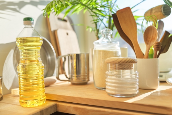 kitchen utensils sunflower oil and flour on wooden table - Солянка рыбная сборная