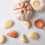 modern art of garlic with segments isolated on white background - Маринованные лисички