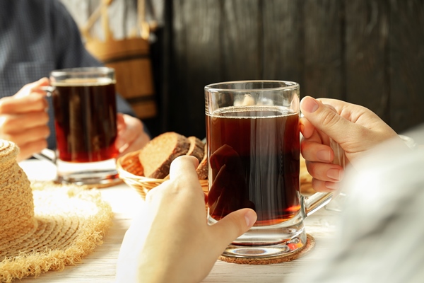 people sitting on the table and drinking kvass - Донецкий квас