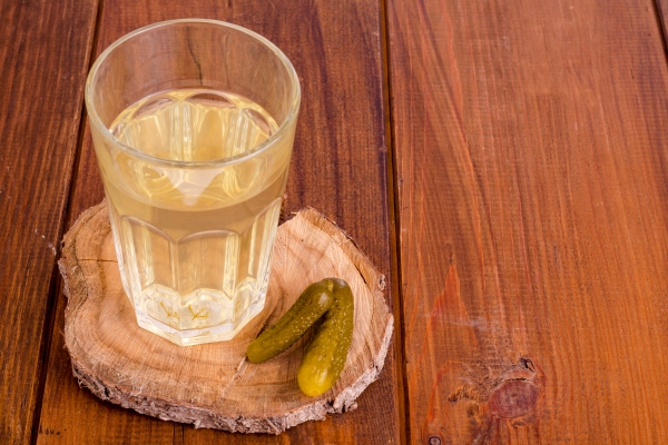 pickle juice glass pickled cucumber on wood - Суп чечевичный