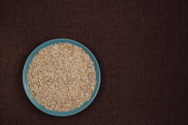 raw oat flakes cereals in blue plate on dark rustic canvas background top view with - Суп-пюре из овощей