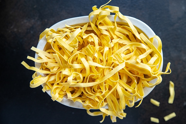 raw pasta home cooking tagliatelle handmade durum wheat fresh meal snack on the table copy space 1 - Суп из фасоли с лапшой