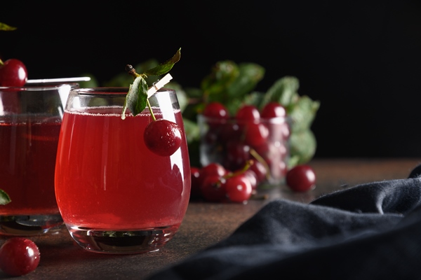 red cherry homemade compote in glasses summer beverage - Уборочный квас