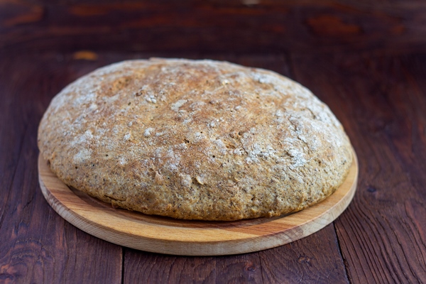rustic rye grain bread on the rustic table just out of the oven - Сыровец