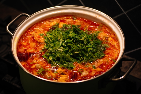 the process of cooking borsch in a saucepan on the dark background national cuisine - Борщ свекольный с перловой крупой