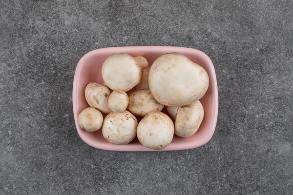 top view pile of fresh organic mushrooms in pink bowl - Драники с шампиньонами