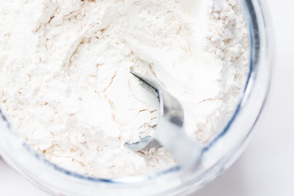 white flour in a large glass jar - Драники с кабачками и луком