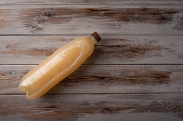 white plastic bottle of beer or light rye kvass on wooden - Старый белый квас
