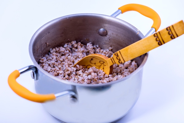 buckwheat porridge in a saucepan with a wooden spoon - Готовим гречневую кашу вместе с детьми