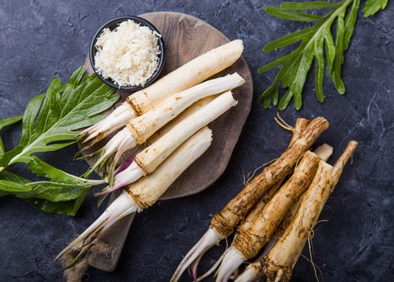 fresh orgaanic horseradish or horse radish root on wooden cutting board - Постная аджика острая