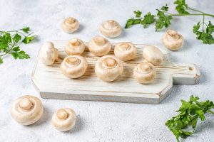 fresh organic white mushrooms champignon top view 300x200 - Постная рыбная кулебяка