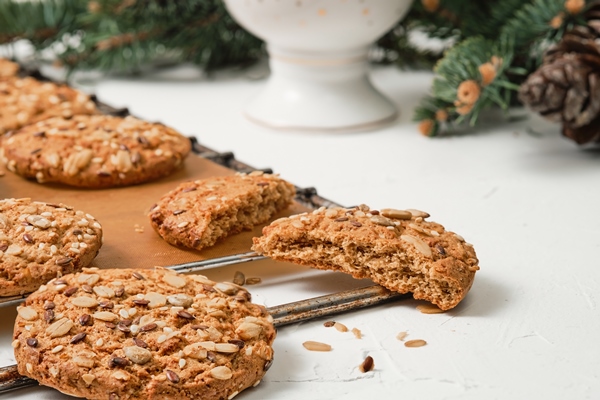 freshly baked oatmeal cookies with sunflower seeds are cooling on a tray the concept of simple homemade baking for the new year or christmas the idea of a healthy diet closeup soft focus - Печенье на рассоле с семечками