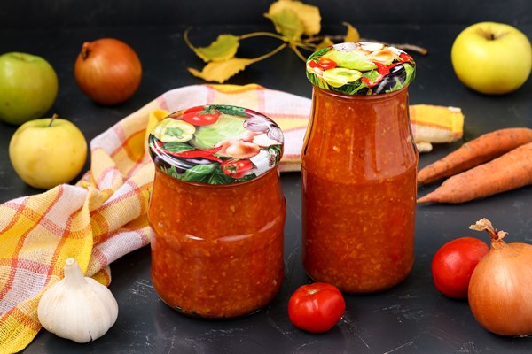 homemade adzhika with tomatoes apples and carrots in jars on a dark background harvesting for the winter 1 - Постная яблочная аджика с базиликом