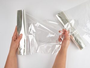 plastic food wrap for baking products in the oven in women s hand - Замороженные яблоки на зиму