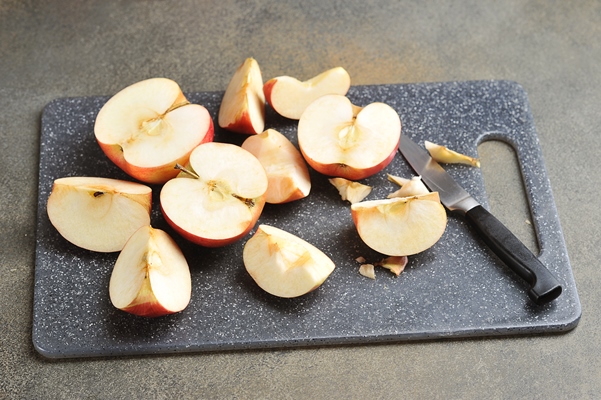sliced red apples on a board with a knife - Постная яблочная аджика с базиликом