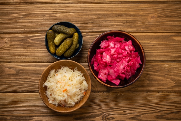 top view of assorted fermented vegetables probiotics and vitamins sources for healthy gut and digestive system kimchi pickles sauerkraut on rustic wooden background preserves and tinned veggies - Винегрет