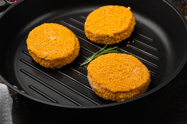 breaded fish patties set on old dark rustic table background - Котлеты из сазана, постный стол