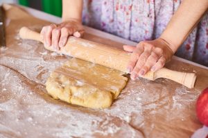 cook at home hands working with dough preparation recipe bread female hands making dough for pizza woman s hands roll the dough mother rolls dough on the kitchen board with a rolling pin - Песочный пирог с яблоком