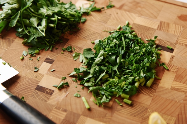 cooking dinner chopped parsley on a cutting board and fresh shrimp on the table - Постное пюре из фасоли и баклажанов