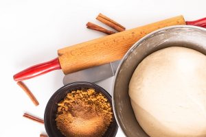 food baking concept bakery preparation proofed bread dough for bread or cinnamon rolls on white - Синнабоны