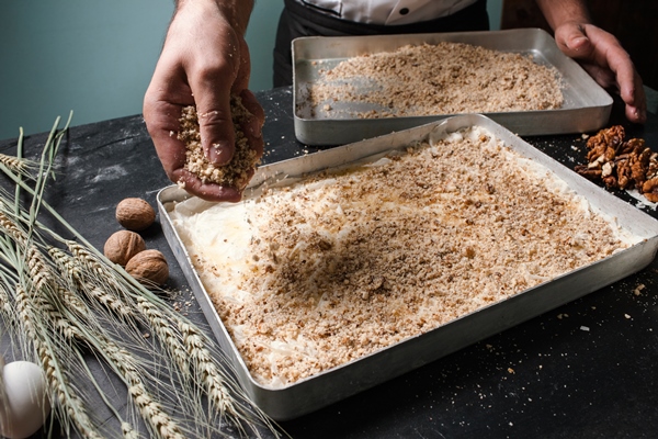 food pastry dessert recipe concept chef making baklava with nuts at restaurant - Пахлава