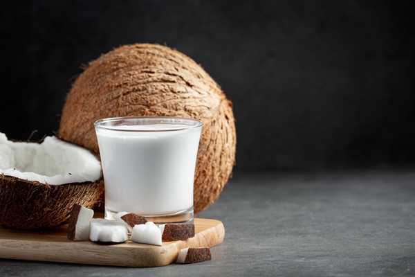 glass of coconut milk put on wooden cutting board - Постный майонез с тофу