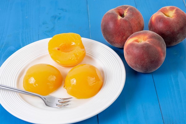 peach compote on the plate with fresh peaches - Канапе из персика, киви и клубники