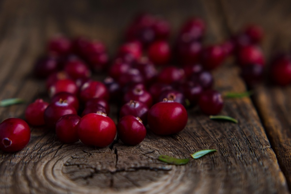 ripe fresh cranberries on an old wooden table close up - Капуста "провансаль"