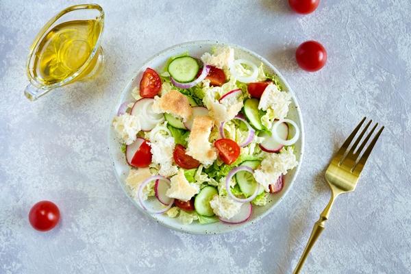 salad fattoush healthy vegetarian food traditional middle eastern salad with toasted pita bread and vegetables in the white plate on the light background close up top view - Салат с перцем и хлебом