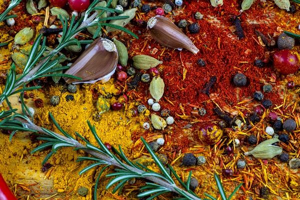 spices and herbs on a wooden table as a background - Жареный редис