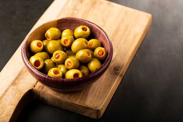 stuffed green olives in a bowl - Салат овощной с сыром тофу