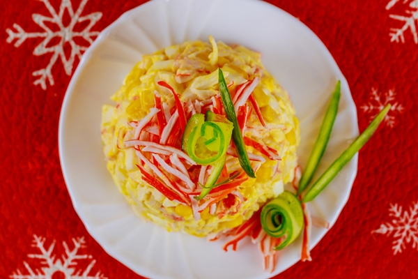 tasty salad with crab meat corn cucumber and eggs for christmas dinner top view 1 - Кукурузный салат с морепродуктами постный