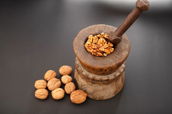 walnuts in antique wooden mortar - Пахлава