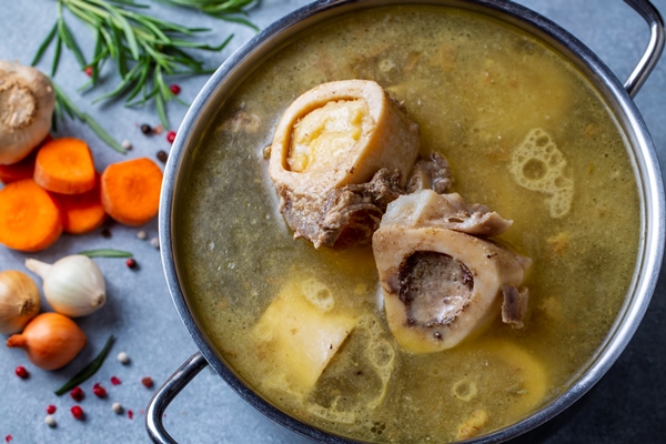 boiled bone and broth homemade beef bone broth is cooked in a pot on bones contain collagen which provides the body with amino acids which are the building blocks of proteins 1 - Прозрачный мясной бульон