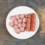 grilled sliced sausages on white plate - Запеканка из макарон